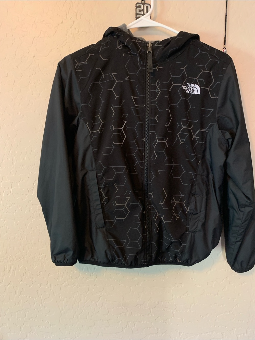 Reversible North Face Black Hooded Kids' Rain Jacket with fleece lining.